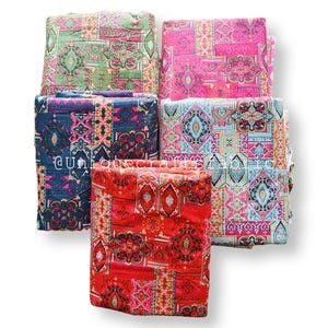 May include: Five folded fabric pieces with colorful, patterned designs. The fabrics feature a mix of pink, blue, green, and red hues with intricate geometric and floral motifs. The text "@uniquecraftsfab" is visible on one of the fabrics.