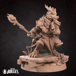 May include: A detailed figurine of a dragon-like humanoid character, holding a staff with a floral top. The figure is in a martial arts pose, wearing armor and standing on a wooden platform. The base has the text "Bite the Bullet".