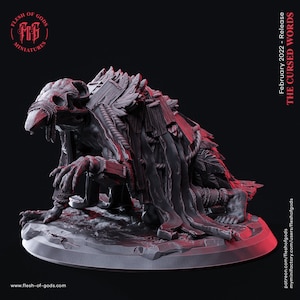 May include: A 3D printed miniature of a creature with a bird skull, wrapped in tattered cloth and rope. The creature is crouched on a circular base. The miniature is painted in a grey color. The text "THE CURSED WORDS" is visible in the background.