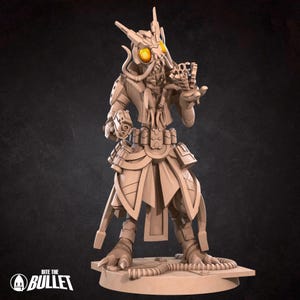 May include: A beige 3D-printed figurine of a futuristic alien warrior. The figure has large, glowing yellow eyes, multiple appendages, and is holding a weapon. The base of the figure has the text "Bite the Bullet".
