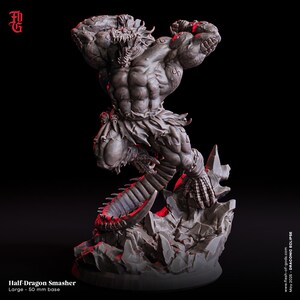 May include: A detailed gray figurine of a Half-Dragon Smasher, posed dynamically on a rocky base. The figure has a muscular physique, dragon-like features, and a menacing expression. The base is approximately 2 inches in diameter. The text "Half-Dragon Smasher" is visible.