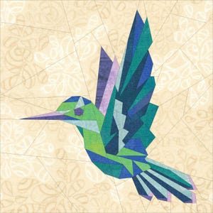 May include: A geometric paper pieced hummingbird with green, blue, and purple wings. The hummingbird is flying with its wings spread out.