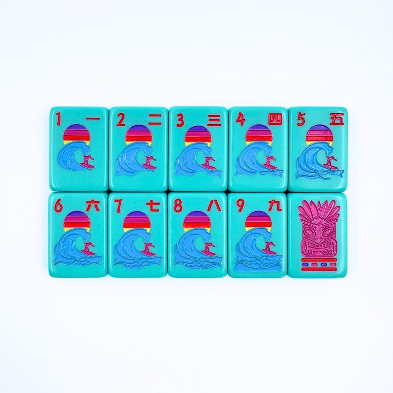 May include: A set of nine turquoise tiles with red and white numbers and Chinese characters. Each tile features a graphic of a surfer riding a wave with a red, orange, and yellow sunset in the background. The last tile features a pink tiki mask.