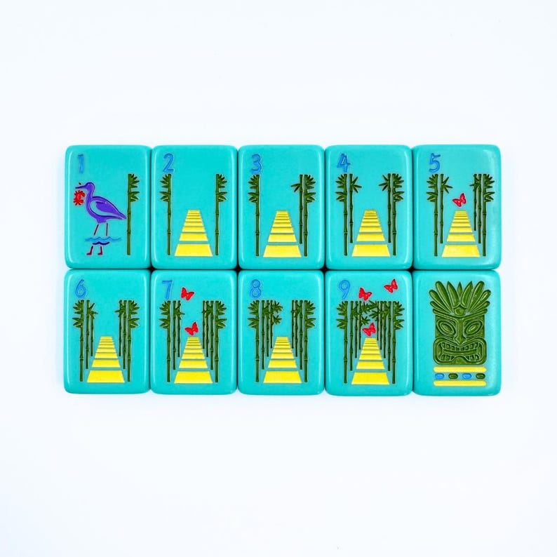 May include: Nine turquoise tiles with white numbers and colorful illustrations. The tiles feature a bird, butterflies, bamboo, and a tiki mask. The tiles are numbered 1 through 9.