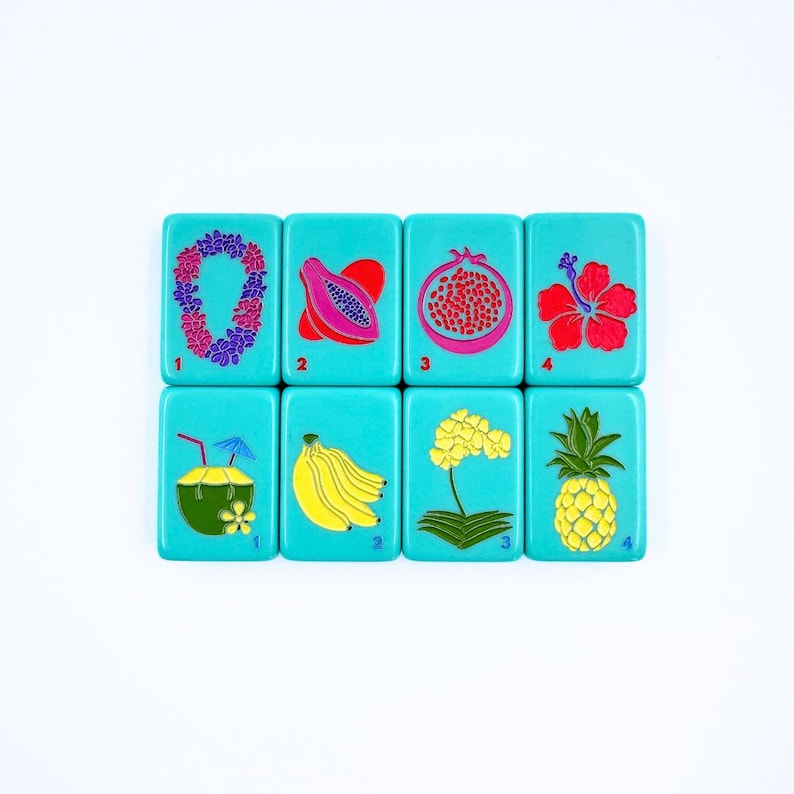 May include: Set of eight turquoise blue tiles with colorful images of tropical fruits, flowers, and drinks. Each tile has a number from 1 to 4.