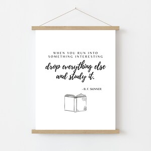 May include: A black and white printable wall art print with a quote about learning: "When you run into something interesting drop everything else and study it." - B.F. Skinner. The quote is accompanied by a simple line drawing of an open book.