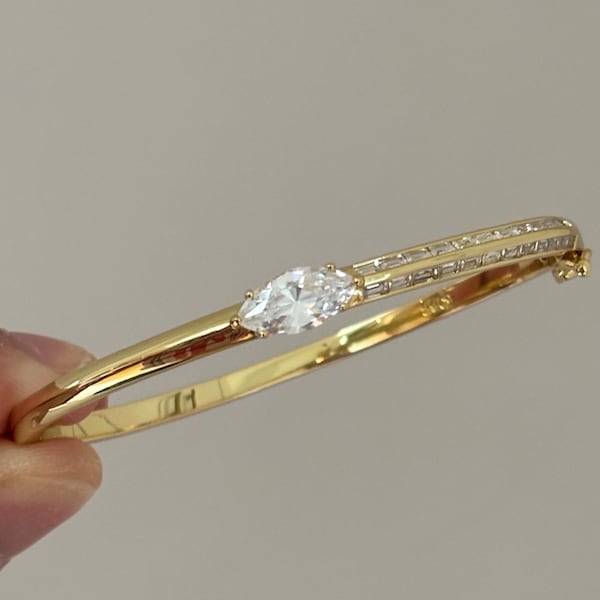 Marquise Solitaire Bangle with Baguette Channel Setting: Gold Plated Cubic Zirconia Bridal Hinged Cuff