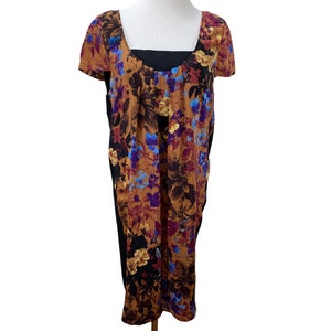 May include: A brown and black floral print dress with short sleeves and a scoop neck. The dress has a black bodice and a brown floral skirt.
