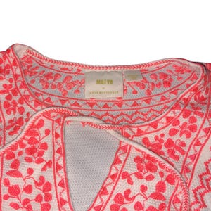 May include: White top with coral embroidery. The embroidery features floral and geometric patterns around the neckline and along the edges. The tag reads "Marvo by Anthropologie".