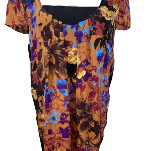 May include: A brown and black floral print blouse with a black scoop neck and short sleeves.