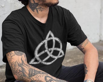 May include: A black t-shirt with a white distressed graphic of a triquetra symbol.