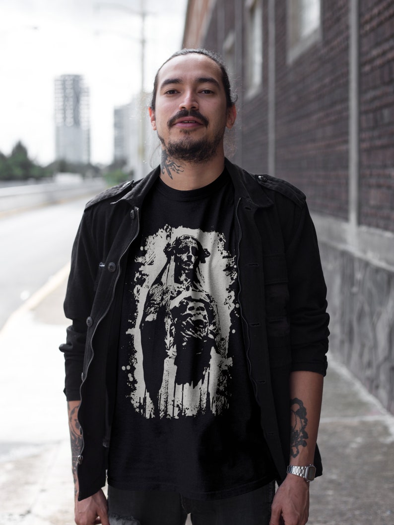 May include: A black t-shirt with a white graphic print of a dog wearing a crown. The dog is standing on a white background with a distressed effect.