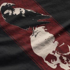 May include: A black and white crow perched on top of a white skull with a red background.