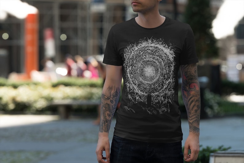 May include: A black t-shirt with a white graphic print of a swirling vortex with a bright white center.