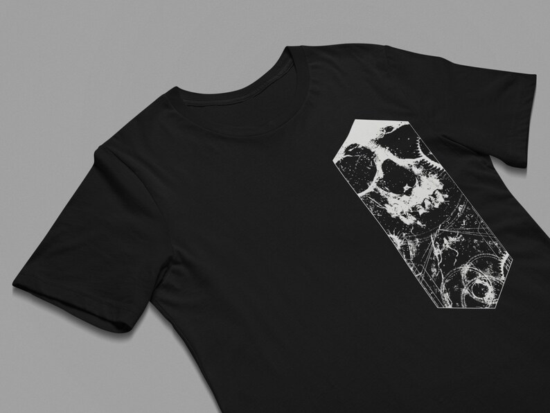 May include: Black t-shirt with a white graphic of a skull with intricate details.