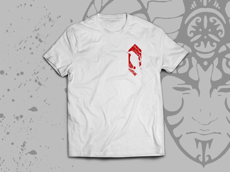 May include: White t-shirt with a red graphic of a stylized bird inside a hexagon.