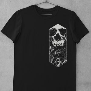 May include: Black t-shirt with a white graphic of a skull with gears and a geometric shape.