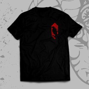 May include: Black t-shirt with a red geometric design featuring a stylized bird silhouette.