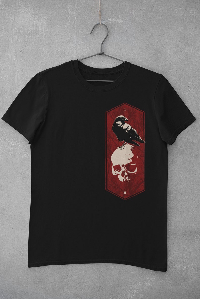 May include: Black t-shirt with a red hexagonal graphic featuring a crow perched on a skull.
