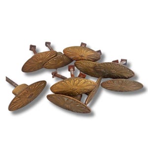 May include: A collection of antique brass oval drawer pulls. Each pull features a detailed floral design and is attached to a screw for mounting. The pulls have a vintage, aged appearance.