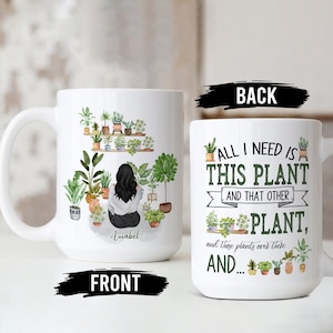 May include: White ceramic mug with a green illustration of a woman surrounded by plants on the front. The back of the mug reads "All I need is this plant and that other plant, and those plants over there, and..."