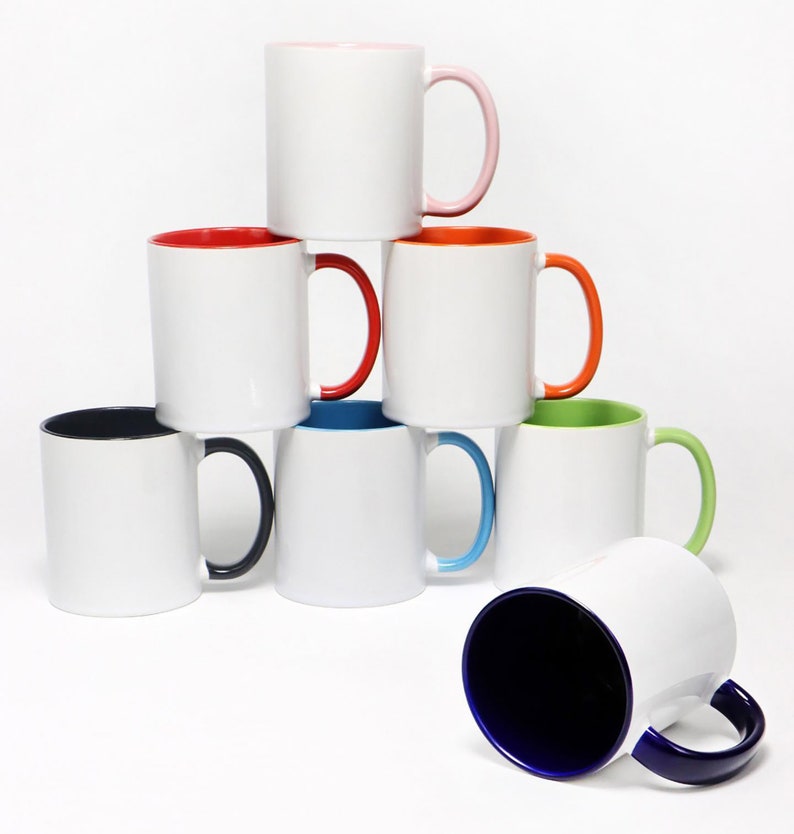May include: A stack of eight white ceramic mugs with different colored rims. The mugs are arranged in a pyramid shape with the top mug having a pink rim, the second row having a red rim and an orange rim, the third row having a blue rim, a green rim, and a black rim, and the bottom row having a blue rim.