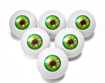 May include: Six white spheres, each with a detailed green and gold iris, arranged in a triangular formation. The eyes have a realistic appearance, with highlights and shadows. The background is plain white.