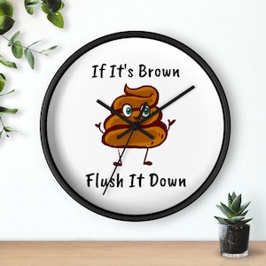 Puede incluir: Un reloj de pared redondo con marco negro y fondo blanco. La esfera del reloj presenta un emoji de caca de dibujos animados con el texto "If It's Brown Flush It Down".
