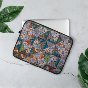 May include: A laptop sleeve with a patchwork design featuring a variety of colors and patterns, including blue, green, orange, and brown. The sleeve is made of a soft, durable material and is perfect for protecting your laptop from scratches and bumps.