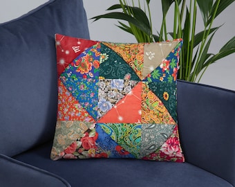 May include: A colorful patchwork pillow with a geometric design. The pillow is made of different fabrics with floral and paisley patterns in shades of red, blue, green, and orange.