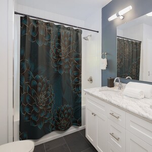 May include: A teal shower curtain with a large floral pattern. The flowers are outlined in gold and have a dark teal center. The background is a dark teal color.