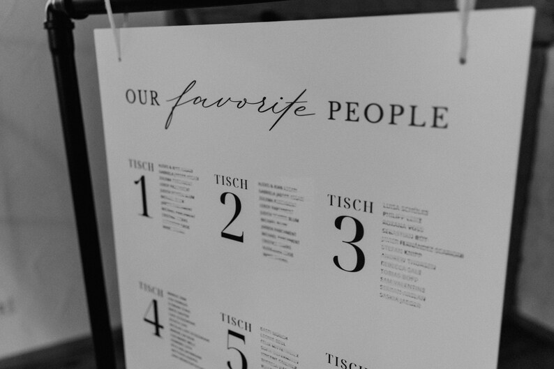 May include: A black and white seating chart with the text "Our favorite people" at the top. The chart lists tables numbered 1 through 5 with names of guests listed under each table number.