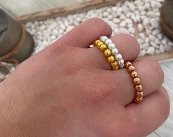 Anelli di perle oro, bianco e bronzo