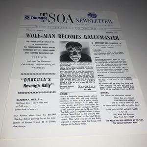 May include: A vintage Triumph Sports Owners Association newsletter from September 1975, featuring a headline about a Wolf-Man and details for a Dracula's Revenge Rally. The white paper document includes black text, a central photograph, and event info.
