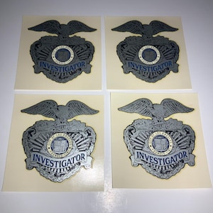 May include: Four vintage silver and blue stickers with an eagle and the words "City of Los Angeles Founded 1781" and "Investigator".