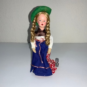 Dancing Wind Up Doll Tin Litho  “Dancing Doll” Vintage German Hand Painted Composition Doll Face  -  Spins Metal Wheels Base Works