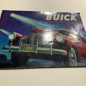 May include: A vintage Buick advertisement showing a red 1941 car under spotlights against a starry night sky. The word "BUICK" is at the top. The car's license plate reads "USA 1941".