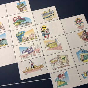 May include: A set of 12 vintage-style motel and hotel logos, each with a unique design and color scheme. The logos feature various architectural styles, including mid-century modern, art deco, and traditional. The logos are printed on white paper and are perfect for use in scrapbooking, card making, or other craft projects.