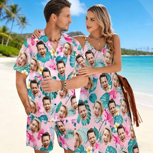 May include: Matching pink Hawaiian shirt and shorts set with a tropical floral and face pattern. A woman wears a matching pink sundress with the same pattern. The outfits are perfect for a beach vacation.