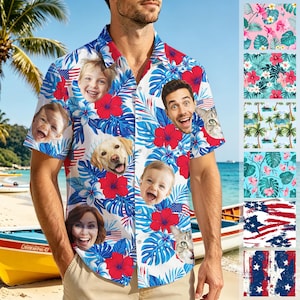 May include: Short-sleeved button-down shirt with a white background, featuring a pattern of red hibiscus flowers, blue leaves, and smiling faces. The shirt also includes American flag accents.
