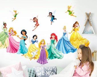May include: Wall decals featuring various Disney princesses in colorful gowns, including Cinderella, Ariel, and Belle. Several fairies are also depicted. The decals are applied to a white wall, creating a whimsical and decorative theme for a child's room.