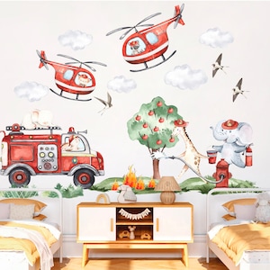 May include: A set of red and white fire truck, helicopter, and animal themed wall decals. The decals feature a fire truck with a white cat inside, two red helicopters with a white cat and a white dog inside, a giraffe holding a hose, an elephant holding a bucket, and a fire hydrant.