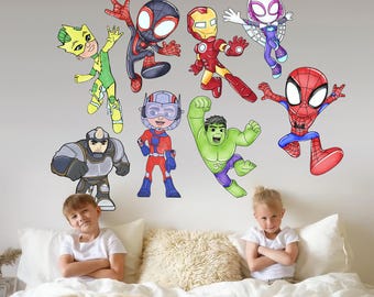 May include: A selection of vibrant superhero wall stickers, featuring characters like Spider-Man and Iron Man, are affixed to a wall. Two children are seated on a bed in front of the wall. The stickers are in a cartoon style.