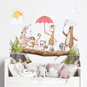 May include: A set of colourful animal wall decals featuring a giraffe, kangaroo, monkey, rabbit, hedgehog, bear, and a duck. The animals are walking on a tree branch with a red umbrella, a fishing rod, and a butterfly net. The decals are perfect for a nursery or child's room.