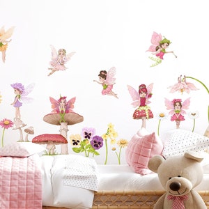May include: Wall decals featuring whimsical fairies with colorful wings and floral accents. The fairies are depicted in various poses, some standing on mushrooms and flowers. The color palette includes pinks, greens, purples, and yellows, creating a cheerful and enchanting atmosphere.
