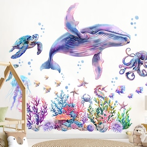 May include: Wall decals depicting an underwater scene with a whale, octopus, sea turtle, and fish. The design includes coral, starfish, and a seahorse. The colour palette features blues, purples, and pinks. Measurements are in centimetres.