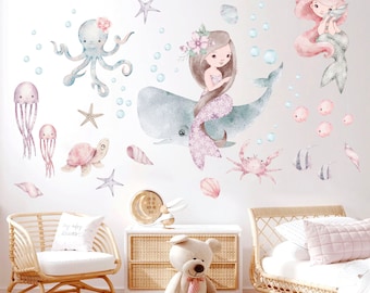 May include: A set of watercolor-style wall decals featuring a mermaid, whale, octopus, turtle, starfish, and other sea creatures. The decals are perfect for a nursery or child's room.