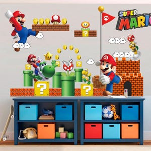 May include: A colorful Super Mario-themed wall decal set featuring Mario, Yoshi, coins, and other iconic characters and elements from the video game. The set includes a brick castle, question mark blocks, and a flag. The decals are arranged on a blue shelf with storage bins.
