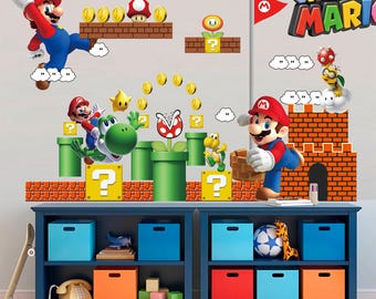 May include: A colorful Super Mario-themed wall decal set featuring Mario, Yoshi, coins, and other iconic characters and elements from the video game. The set includes a brick castle, question mark blocks, and a flag. The decals are arranged on a blue shelf with storage bins.