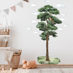 May include: A watercolour wall decal featuring a tall green tree with a small squirrel sitting on a branch. The tree is surrounded by white clouds and a green grassy area at the base.